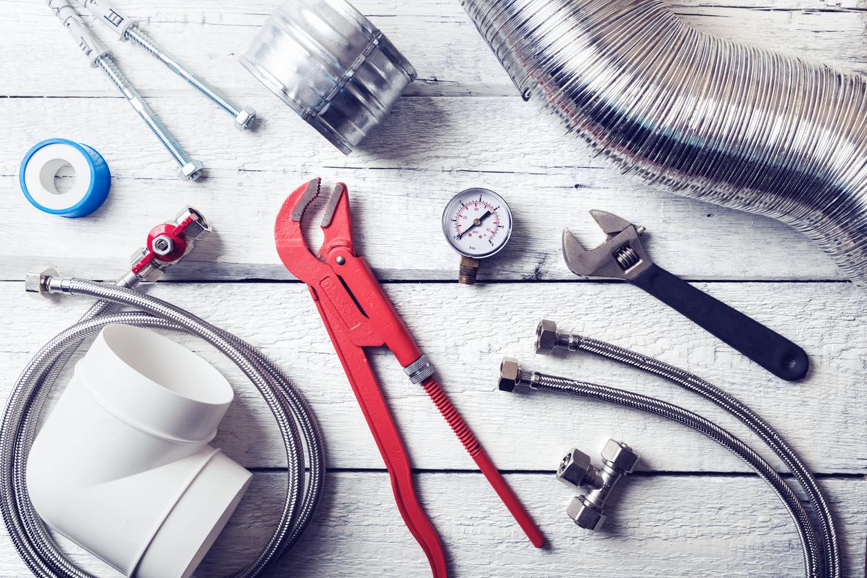 Toolbox with tools for air conditioning maintenance, including screwdrivers, wrenches, and multimeter.